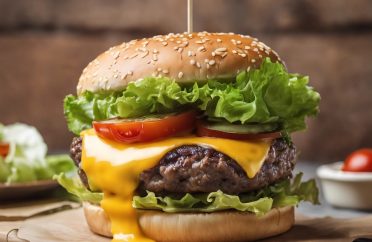 A juicy hamburger. Close-up shot featuring a thick beef patty, melted cheese, crispy lettuce, ripe tomatoes