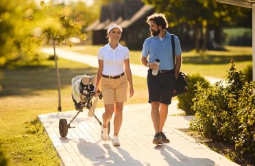 Happy couple of golfers enjoying a golf weekend. Copy space.